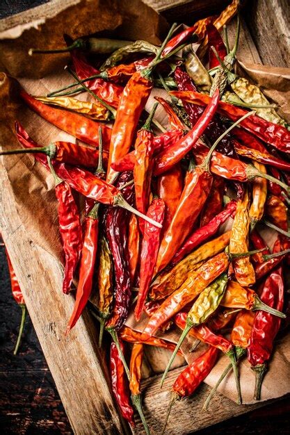 Premium Photo | Dried chili peppers in a wooden tray