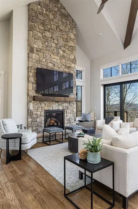 A Modern Chalet Living Room With A Stone Fireplace Neutral Seating