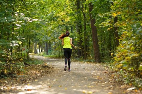 Premium Photo Woman Running At Forest