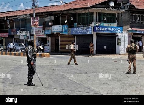 Crpf And Kashmir Police Cops Stop Public Movement Near A Temporary Check Post During A Caso In