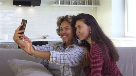 Asian And African American Black Woman Taking Selfie Using Smartphone