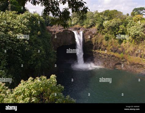 Rainbow Falls And Greenery On The Wailuku River Framed By Overhead Tree