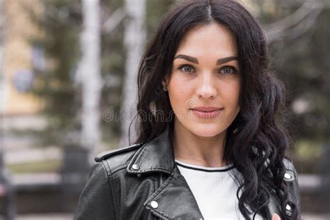 Beautiful Brunette Woman With Curly Hair Posing On The Street While Walking Stock Photo Image