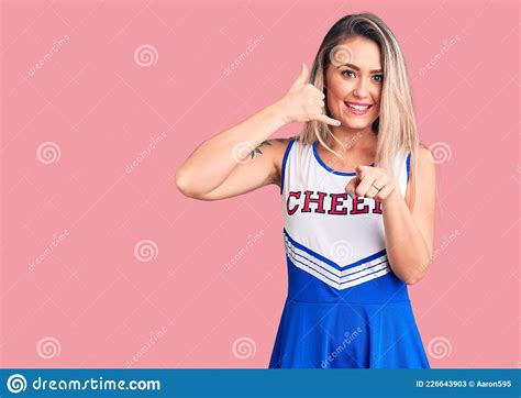 Young Beautiful Blonde Woman Wearing Cheerleader Uniform Smiling Doing