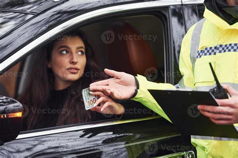 Male Police Officer In Green Uniform Takes Bribe From Woman In Car