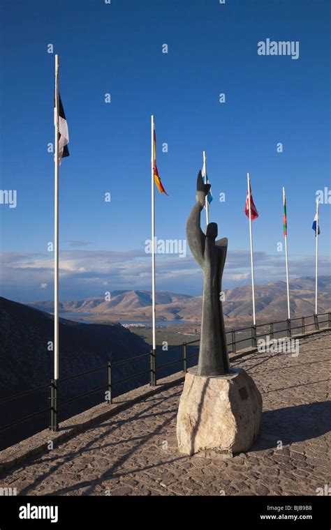 Flags And Modern Statue Of Prometheus In Delphigreece Stock Photo Alamy