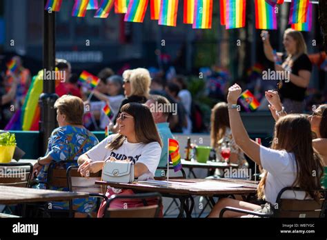 People Watch The Pride Cymru 2019 Parade From A Street Side Bar In