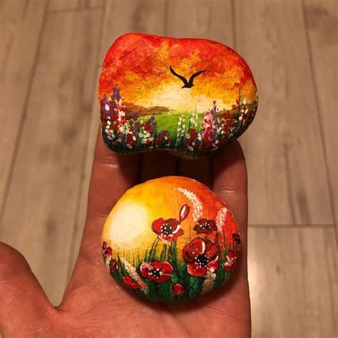 Two Painted Rocks In The Palm Of Someone S Hand