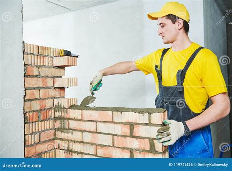 Bricklaying Construction Worker Building A Brick Wall Stock Photo