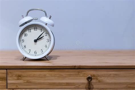 White Alarm Clock On Wooden Desk Stock Image - Image of soft, room ...