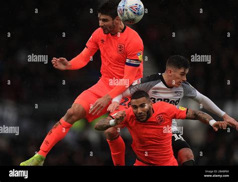 Derby County's Tom Lawrence and Huddersfield Town's Danny Simpson and Christopher Schindler ...