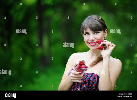 Beautiful Brunette Girl With Strawberry Stock Photo Alamy