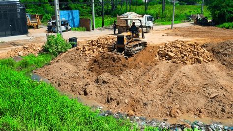 Hard Working Komatsu Bulldozer Spreading Soil On Road Foundation With