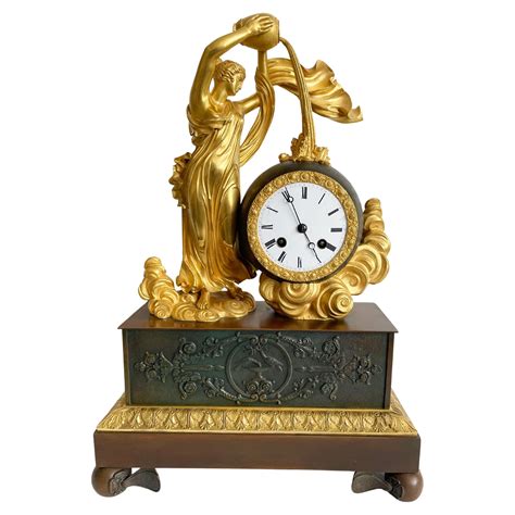 Reloj de sobremesa Imperio Bronce patinado y dorado Cleret París