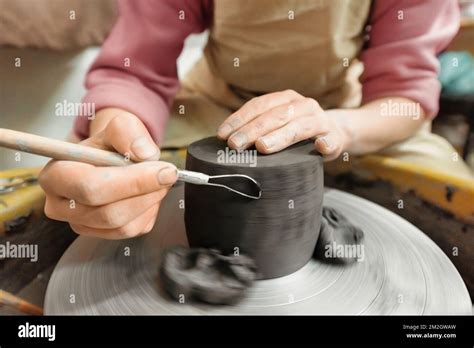 The Master Of Sculpting Pottery Working In A Studio Shaping The Clay