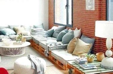 A Living Room Filled With Lots Of Furniture And A Brick Wall Behind The