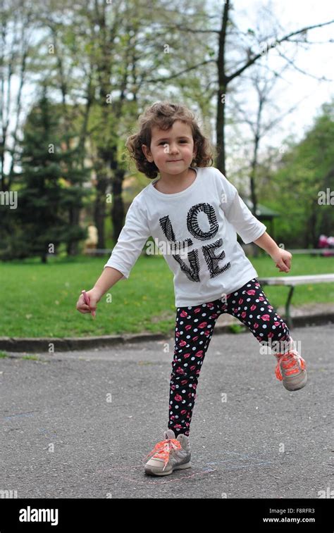 Girl Playing Hopscotch In Street Stock Photo Alamy