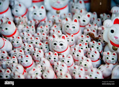 Traditional Waving Cat Statues Also Known As Maneki Neko At Gotokuji