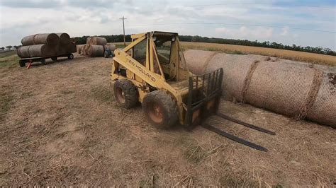 New Holland L Skid Steer Stacking Round Bales Youtube