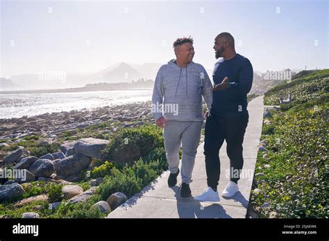 Gay Couple Walking In Landscape Stock Photo Alamy