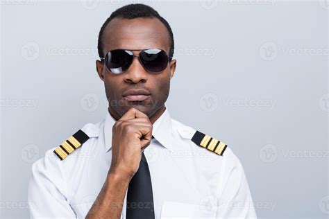 Confident And Experienced Pilot Confident African Pilot In Uniform