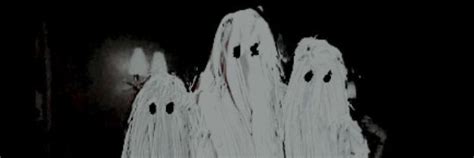 two ghostly ghost figures standing in the dark