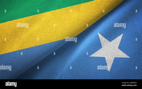 Gabon And Somalia Two Flags Textile Cloth Fabric Texture Stock Photo