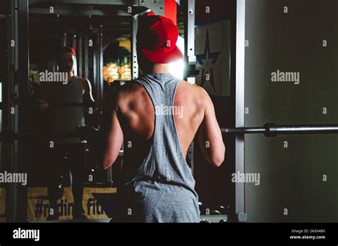 Strength training of a muscular young athlete in the gym. Stamina and ...