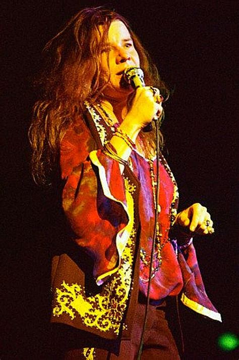 A Woman Singing Into A Microphone On Stage