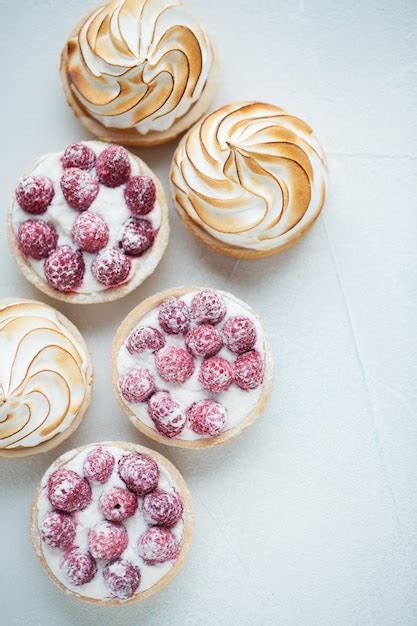 Premium Photo Delicious Lemon And Raspberry Tartlets With Meringue On