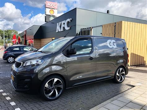 Grey Van Parked In Front Of A Building