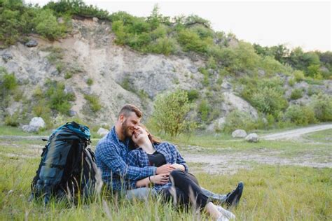 Premium Photo Hikers With Backpacks Relaxing On Top Of A Hill And