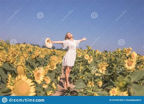 Beauty Sunlit Woman On Yellow Sunflower Field Freedom And Happiness