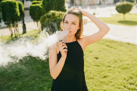 Premium Photo Side View Of Young Beautiful Girl Vaping E Cigarette