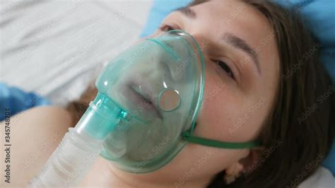 A patient with an oxygen mask in a hospital with a pandemic of the ...