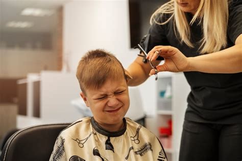 Free Photo | Boy getting haircut at salon front view