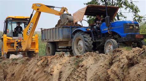 JCB Backhoe Cutting Soil And Loading In Tractor JCB 3DX Machine