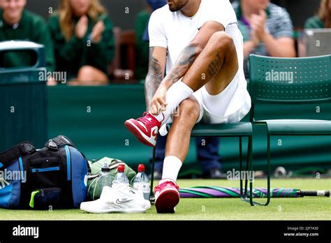 Australia S Nick Kyrgios Changes Into A Pair Of Red And White Nike Air