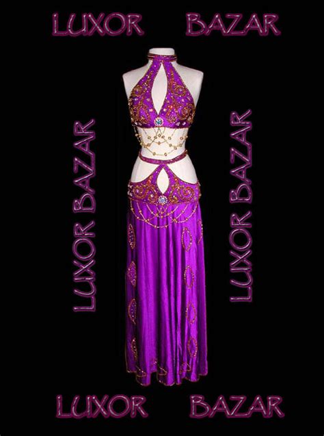 A Woman In A Purple Belly Dance Outfit With The Words Luxury Bazaar On