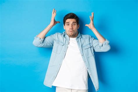 Free Photo Distressed Guy Showing Mind Blowing Gesture Looking