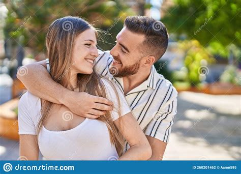 Man And Woman Couple Smiling Confident Hugging Each Other At Park Stock