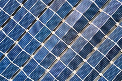 Aerial View Of Solar Power Plant With Blue Photovoltaic Panels Mounted On Industrial Building