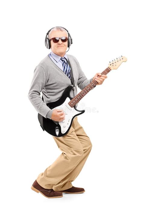 Full Length Portrait Of A Mature Man With Glasses Playing Guitar Stock