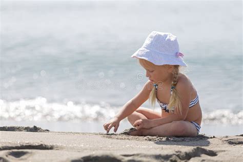 Menina Que Senta Se Na Praia Imagem De Stock Imagem De Jogar Litoral