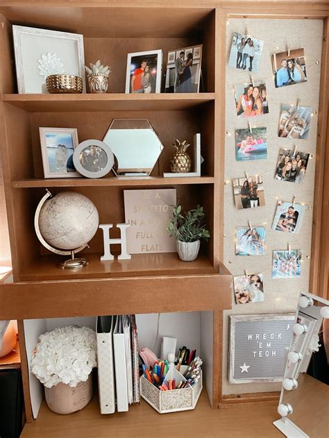 A Book Shelf Filled With Lots Of Books And Pictures Next To A Desk