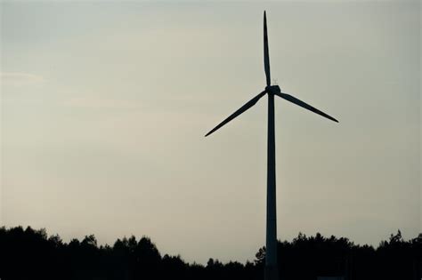 Premium Photo View Of A Modern Windmill Against A Blue Sky The White Blades Of The Wind