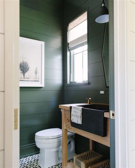 An Instagram Photo Of A Bathroom With Dark Green Walls And White Tile