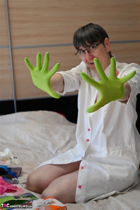 Amateur Woman Kneels On Her Bed While Donning Layers Of Latex Gloves