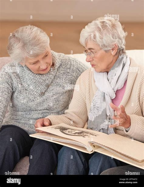 Some Memories Never Fade Seniors Looking Through A Photo Album Stock