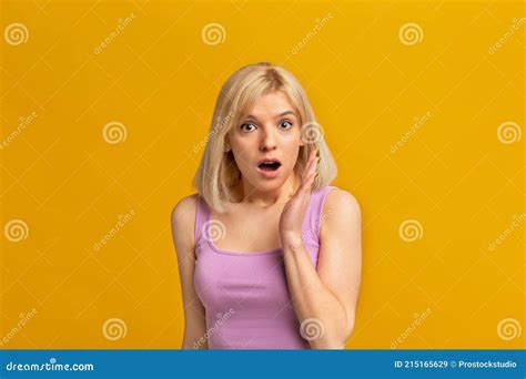 Don T Tell Anybody Shocked Blonde Woman Keeping Hand Near Opened Mouth